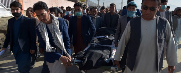 Shiite mourners carry the body of a schoolgirl, who died in multiple blasts outside a girls' school, for burial in Dasht-e-Barchi on the outskirts of Kabul on 9 May 2021, as the death toll has risen to 50, the interior ministry said. Picture: AFP