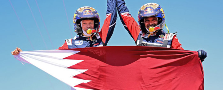 Toyota's driver Nasser Al-Attiyah of Qatar (R) and his co-driver Mathieu Baumel of France celebrate their victory after winning the Dakar Rally 2022, at the end of the last stage between Bisha and Jeddah in Saudi Arabia, on 14 January 2022. Picture: FRANCK FIFE/AFP