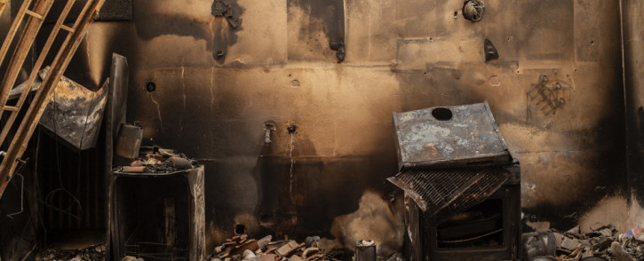 This photograph shows the inside of a burnt house following a wildfire in the village of Kastri on Evia (Euboea) island, on August 10, 2021. Nearly 900 firefighters, reinforced overnight with fresh arrivals from abroad, were deployed on the country's second largest island as major towns and resorts remained under threat from a fire that has been burning for eight days.