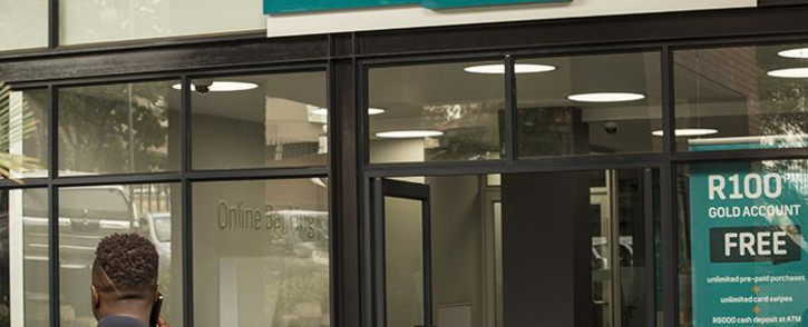 A man sits at the entrance to the FNB Randburg branch in Johannesburg. Picture: EWN.