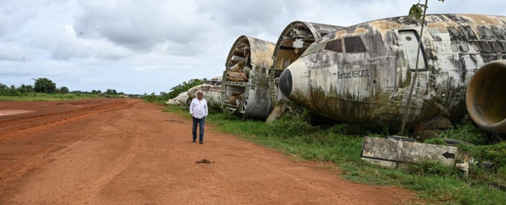 Aziz Alibhai walks past the wreckage of aeroplanes that he had displayed on the edge of a landing strip on April 15, 2022 in Songon Dagbe in the Jacqueville region. Picture: Sia Kambou / AFP