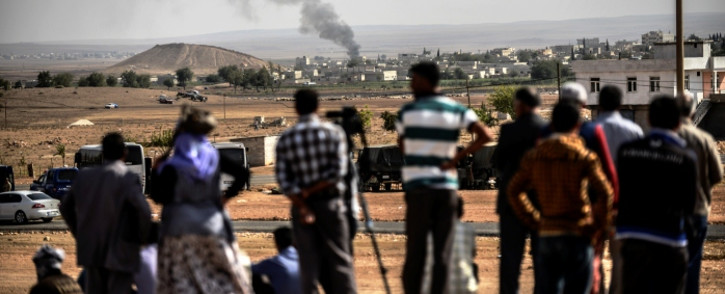 FILE: Smoke rises from the Syrian town of Kobani, seen from near the Mursitpinar border crossing on the Turkish-Syrian border. Picture: AFP. 