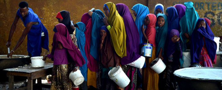 FILE: A severe drought is threatening famine in Somalia, where the UN estimates 5.5 million people at risk. Young girls line up at a feeding centre in Mogadishu. Picture:  United Nations Photo.