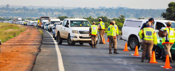 Traffic officers conduct checks at a roadblock. Picture: @Dotransport/Twitter