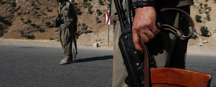 A member of the Kurdistan Workers Party (PKK) carries an automatic rifle on a road in the Qandil Mountains, the PKK headquarters in northern Iraq, on 22 June 2018. Picture: AFP.