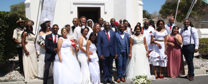 12 Couples stand in front of a small church on Robben Island after getting married on Valentines Day. Picture: Bertram Malgas