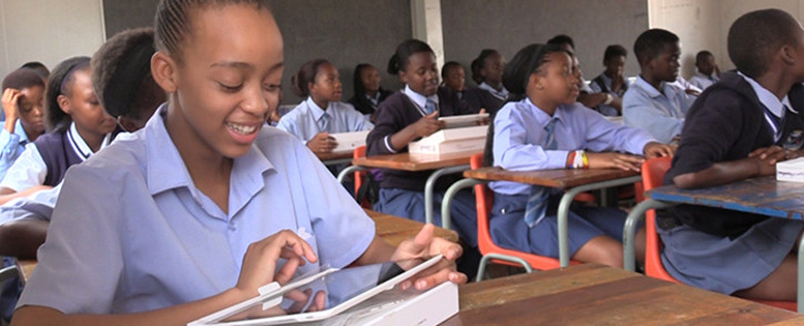 A gauteng pupil smiles as she inpects her new tablet, Picture: Vumani Mkhize/EWN.