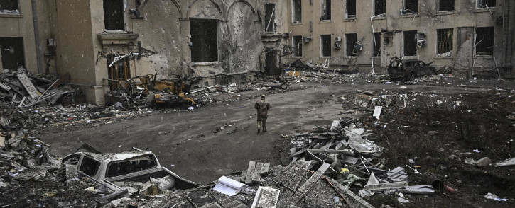 A Ukranian serviceman walks between rubble of the destroyed regional headquarters of Kharkiv on 27 March 2022. Picture: Aris Messinis/AFP