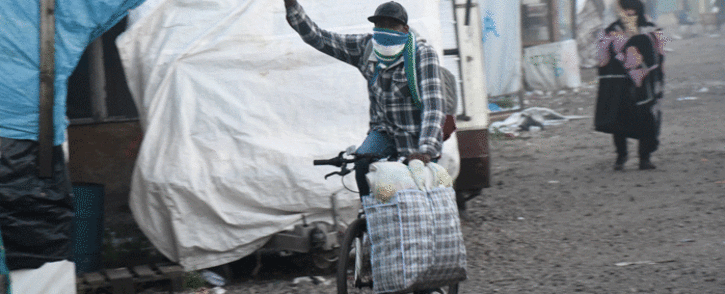 FILE: A migrant rides a bike during the full evacuation of the Calais 'Jungle' camp, in Calais, northern France, on October 25, 2016. Picture: AFP