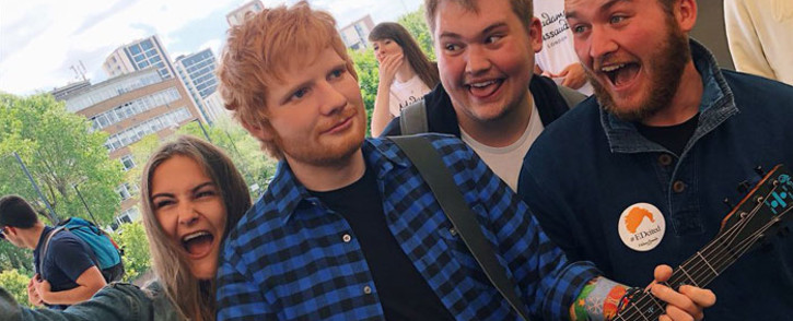 FILE: Fans gather around a wax figure of British musician Ed Sheeran at Madame Tussauds in London. Picture: @MadameTussauds/Twitter