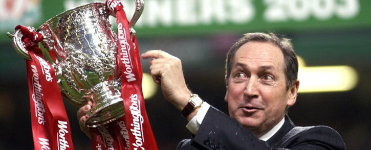 FILE: Liverpool's French manager Gerard Houllier holds the cup aloft celebrating victory over Manchester United in the Worthington Cup Final at the Millenium stadium in Cardiff 2 March 2003. Picture: AFP