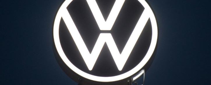 This picture taken on 9 September 2019 shows workers unveiling an illuminated logo of German carmaker Volkswagen (VW) at the company's headquarters in Wolfsburg, northern Germany. Picture: AFP