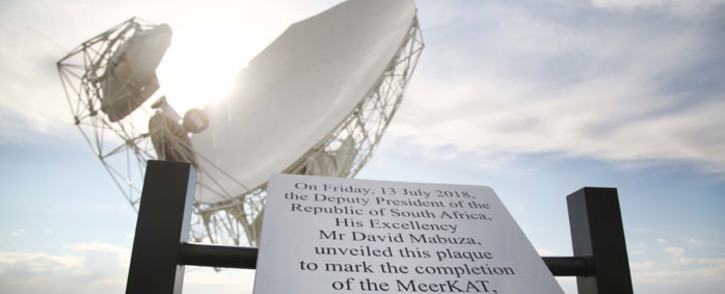 One of the 64 radio telescopes that are part of the MeerKAT project behind a plaque unveiled by Deputy President David Mabuza. Picture: Bertram Malgas/EWN