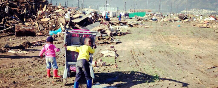 Children in Nomzamo searching through rubble trying to source material to rebuild their house on 13 June 2014. Picture: Carmel Loggenberg/EWN.