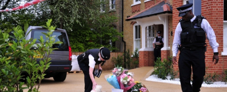 FILE: Officers outside a house in New Malden, south London on 23 April 2014 after three children were found dead at the house on the previous day.Picture:AFP.