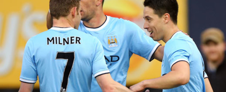 Manchester City’s Samir Nasri is congratulated by James Milner and Edin Dzeko after he scored a goal against Chelsea at Yankee Stadium in New York on 25 May 2013. City beat Chelsea 5-3. Picture: AFP