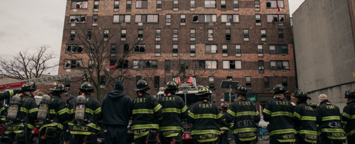 Emergency first responders remain at the scene after an intense fire at a 19-story residential building that erupted in the morning on 9 January 2022 in the Bronx borough of New York City. Picture: Scott Heins/Getty Images/AFP