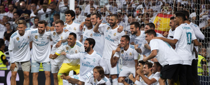 Real Madrid's players pose as they celebrate their Supercup after winning the second leg of the Spanish Supercup football match Real Madrid vs FC Barcelona at the Santiago Bernabeu stadium in Madrid, on 16 August, 2017. Picture: AFP.