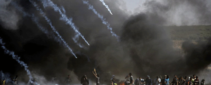 Tear gas is fired at protestors during clashes with Israeli forces near the border between the Gaza Strip and Israel, east of Gaza City on 14 May 2018, following the controversial move to Jerusalem of the United States embassy. Picture: AFP