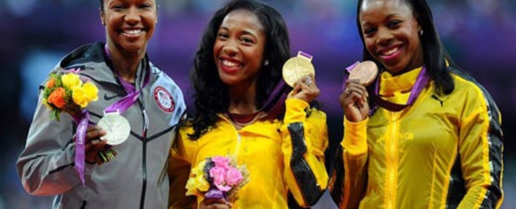 (L-R) Silver medalist Carmelita Jeter of the US, gold medalist Shelly-Ann Fraser-Pryce of Jamaica and bronze medalist Veronica Campbell-Brown of Jamaica pose on the podium for women's 100m at the London Games. Picture: London2012.com.
