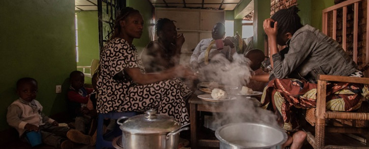 Chirhuza Zagabe's (not seen) family eats lunch in the kitchen in Bukavu, eastern Democratic Republic of Congo, on 20 March 2022. Chirhuza Zagabe, 60, is a pastor of the Primitive Church of the Lord and manager of the provincial branch of an oil company. Picture: Guerchom Ndebo/AFP