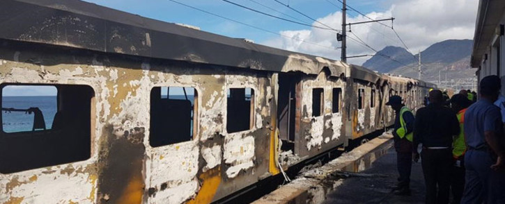Officials assess the damage of a train fire at Glencairn station on 7 October 2019. Picture: 1 Second Alerts