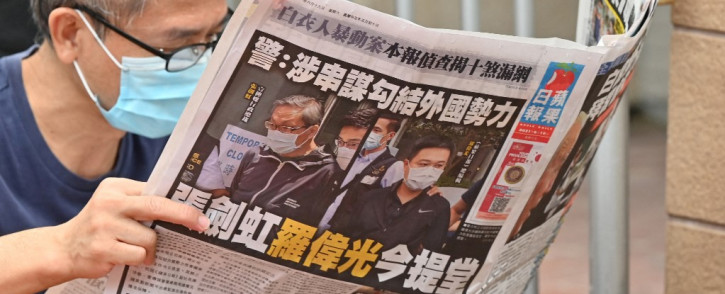 This file photo taken on June 19, 2021 shows a supporter reading a copy of the Apple Daily newspaper outside a court in Hong Kong, after the two Apple employees were charged with collusion over their newspaper's coverage after authorities deployed a sweeping security law. Hong Kong's pro-democracy newspaper Apple Daily will print its final edition "no later than Saturday", bosses confirmed on June 23, 2021, after police froze accounts and arrested staff using a new national security law.
Peter PARKS / AFP
