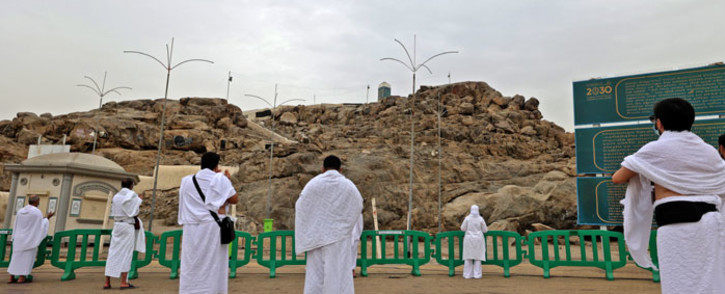 Muslim pilgrims pray next to Saudi Arabia's Mount Arafat, also known as Jabal al-Rahma (Mount of Mercy), southeast of the holy city of Mecca, during the climax of the Hajj pilgrimage amid the COVID-19 pandemic, next to 19 July 2021. Picture: Fayez Nureldine/AFP