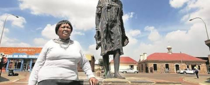 Nokuthula Simelane's mother, Ernestinah Simelane, stands next to the life-size statue of her daughter, erected in her hometown of Bethal. Picture: Supplied by Simelane family
