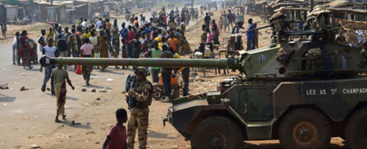 French troops of the Sangaris Operation take position with a Sagaie tank in the PK12 district of Bangui on 16 January, 2014. At least seven people were killed in overnight violence in Bangui, according to a compiled toll from the Red Cross and AFP. Picture: AFP
