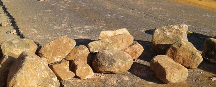 FILE: Rocks blockade a road during a protest. Picture: @SAPoliceService/Twitter
