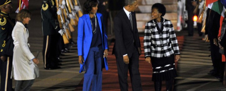 US President Barack Obama and his wife Michelle are received by Minister of International Relations and Cooperation Maite Nkoana-Mashabane after landing at the Waterkloof Airforce Base in Pretoria on Friday evening, 28 June 2013. Picture: GCIS/SAPA