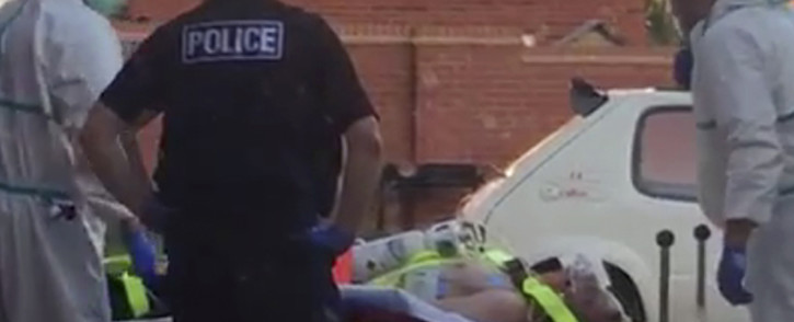 A still image taken from video footage recorded on 30 June 2018 and released to AFP on 5 July 2018 shows a man on a stretcher being put into an ambulance by medics and police outside a residential address in Amesbury, southern England, on 30 June 2018 where police reported a man and woman were found unconscious in circumstances that sparked a major incident after contact with what was later identified as the nerve agent Novichok. Picture: AFP.