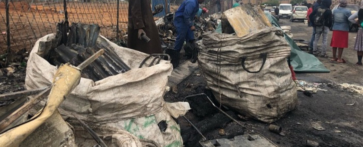 Waste pickers are taking the scrap metal from the fire in Alexandra. Picture: Mia Lindeque/EWN