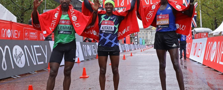 Third place, Ethiopia's Sisay Lemma (L), winner Ethiopia's Shura Kitata (C), and runner-up Kenya's Vincent Kipchumba (R) pose at the finish of the elite men's race of the 2020 London Marathon in central London on 4 October 2020. Picture: AFP.