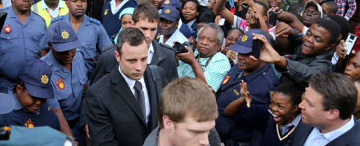 Oscar Pistorius leaves the High Court in Pretoria after the seventh day of his murder trial on 11 March 2014. Picture: Sebabatso Mosamo/EWN.