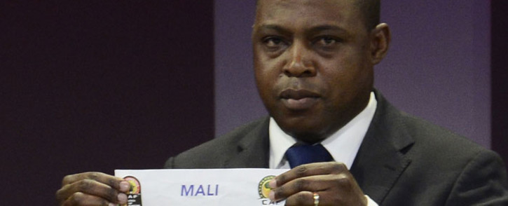 FILE: Former football player Kalusha Bwalya of Zambia shows the paper of Mali during the final draw of the Africa Cup of Nations. Picture: AFP.
