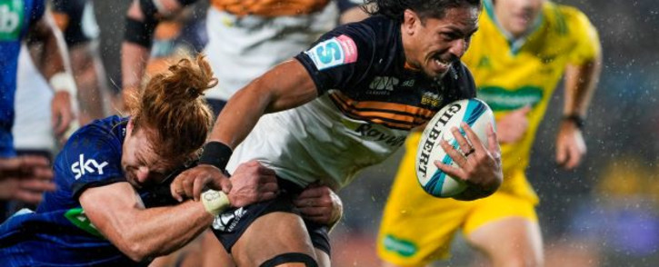 Brumbies' Pete Samu (R) is tackled by Blues' Tom Robinson during the Super Rugby Pacific semifinal match between Australia's Brumbies and New Zealand's Blues at Eden Park in Auckland on June 11, 2022.