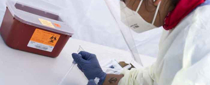 FILE: A health worker process a COVID-19 antibody test after getting the blood from the patient. Picture: AFP.
