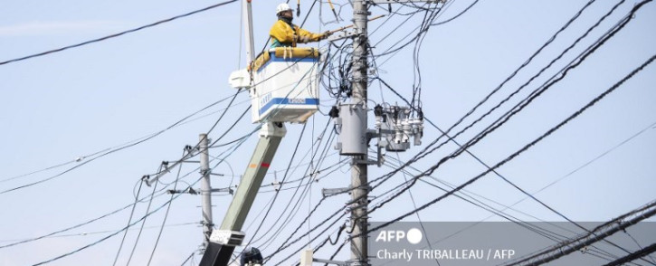A worker conducts electrical work following a power outage in Soma, Fukushima Prefecture on March 17, 2022. Picture: Charly TRIBALLEAU / AFP