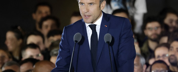 French President and La Republique en Marche (LREM) party candidate for re-election Emmanuel Macron gestures as he delivers a speech after his victory in France's presidential election, at the Champ de Mars in Paris, on 24 April 2022. Picture: Ludovic MARIN/AFP