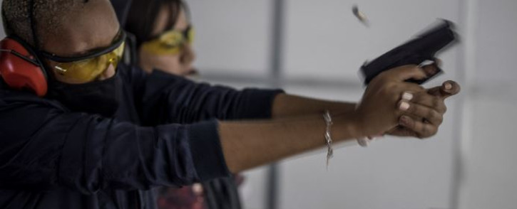 A spent shell leaves a pistol fired by a woman as she takes part in training organised by the women empowerment group Girls on Fire, in Midrand, on 7 February 2021. Picture: MARCO LONGARI/AFP