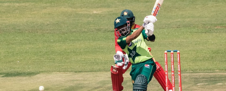 Pakistan's Babar Azam plays a shot as wicket keeper Regis Chakabva looks on during the third Twenty20 international cricket match between Zimbabwe and Pakistan at the Harare Sports Club in Harare on April 25, 2021. Picture: Jekesai Njikizana / AFP