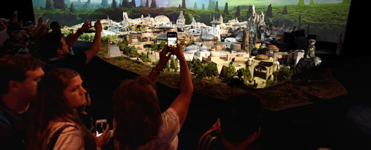 'Star Wars' fans view plans at the California and Florida Disneylands for the new development that will open in 2019 during the D23 expo fan convention at the Convention Center in Anaheim, California, on 16 July 2017. Picture: AFP.