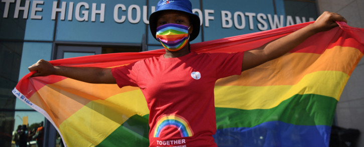 Activists carry a rainbow flag outside the Botswana High Court on 12 October 2021 where they gathered to listen to the court proceedings as the goverment of Botswana appeals against the Botswana High Court ruling to decriminalise homosexuality. Picture: Monirul Bhuiyan/AFP