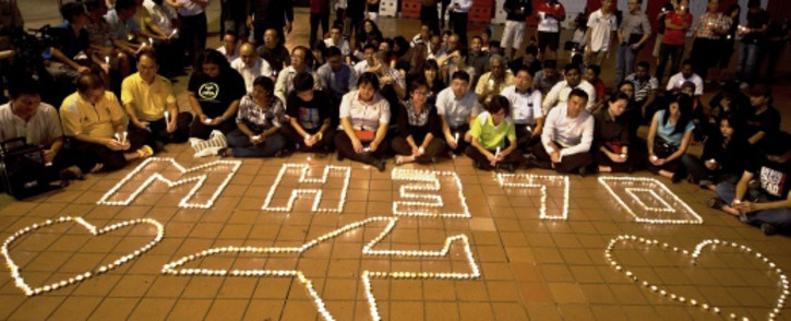 FILE: Malaysians take part in a candle-light vigil to mark the one-month anniversary of the missing Malaysia Airlines MH370 flight. Picture: AFP.