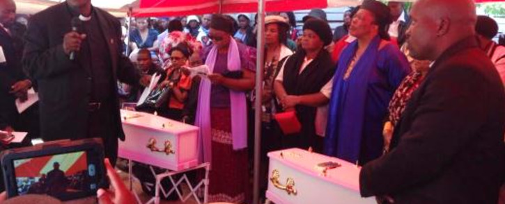 FILE: Mourners gather around the tiny coffins of Yonelisa and Zandile Mali on 19 October 2013 after they were found raped and murdered in Diepsloot. Picture: EWN