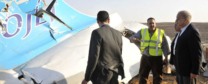 A handout picture released by Egypt's Prime Minister's office on 31 October 2015, shows PM Sherif Ismail (R) at the site of the wreckage of a crashed A321 Russian airliner in Hassana a mountainous area of Egypt's Sinai Peninsula. Picture: AFP