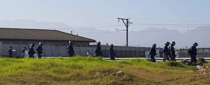 FILE: Police on the scene of a land invasion in Somerset West. Picture: @senkamin/Twitter