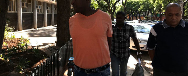 Crime Intelligence operative Morris Tshabalala (in orange) arrives at the Pretoria Commercial Crimes Court on 19 January 2018. Picture: Barry Bateman/EWN